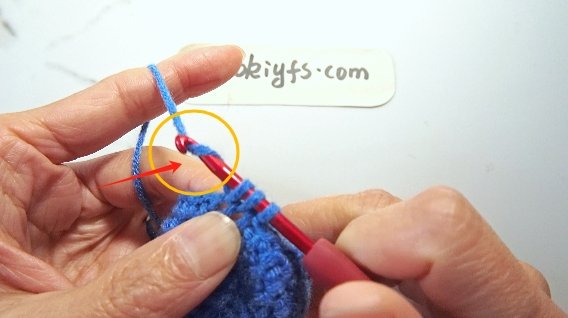 Yarn over .Pull through all three loops.