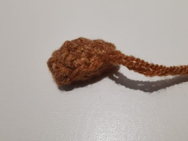 Ears flattened with yarn needle