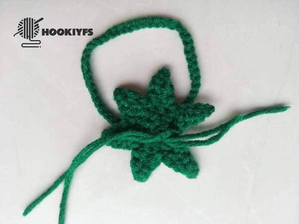 hand carrying tie knot on the back of leaf