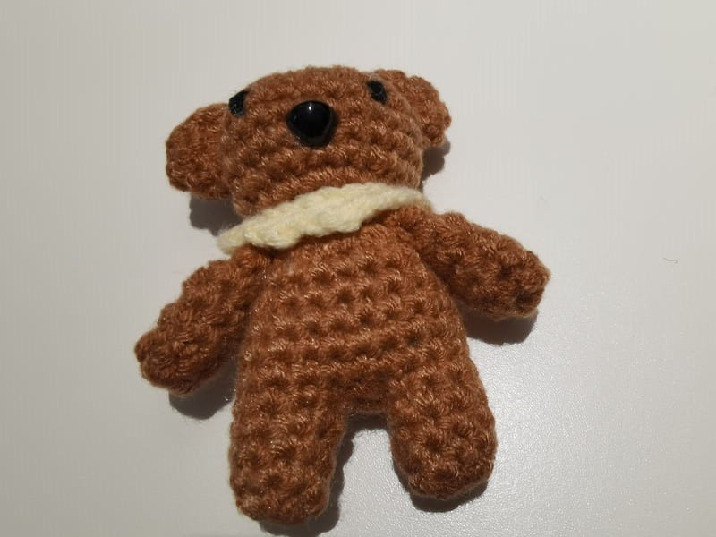 safe mouth and sew the eyes on the body of teddy bear crochet