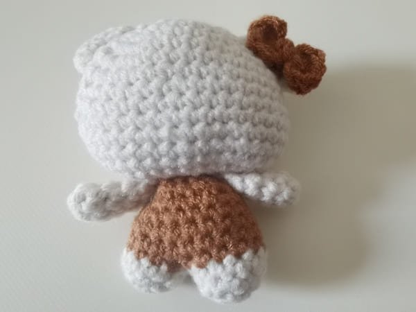 sew the bow on the light ear of hello kitty