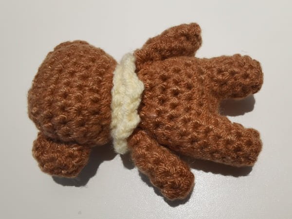 sew two arms on the body of teddy bear