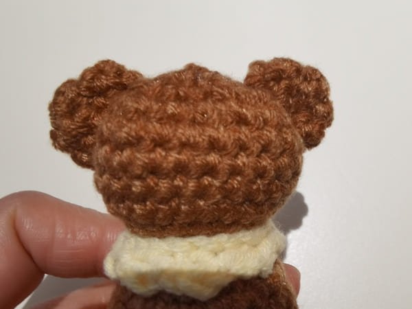sew two ears on the body of teddy bear