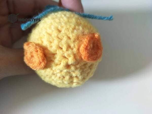 sewing the feet on the body for duck crochet
