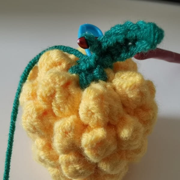 the first leaf is completed for round 9 for pineapple crochet pattern