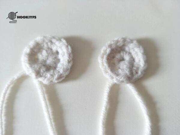 two piece of eyes are completed for crochet frog pattern