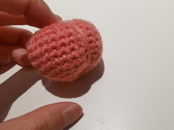 use the yarn needle with yarn to make the peach shape