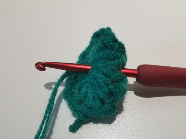 Insert the hook from the fabric on the right