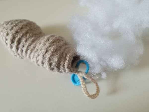 put fiberfill in to hole of peanut body