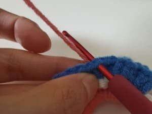 put the pink yarn behind the blue fabric