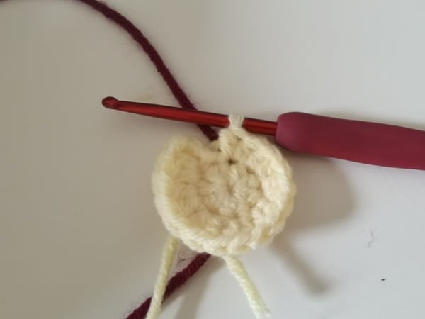 put the wine red yarn behind the fabric