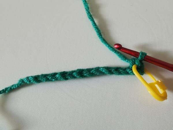 the first single crochet is completed with yellow marker for frog crochet pattern