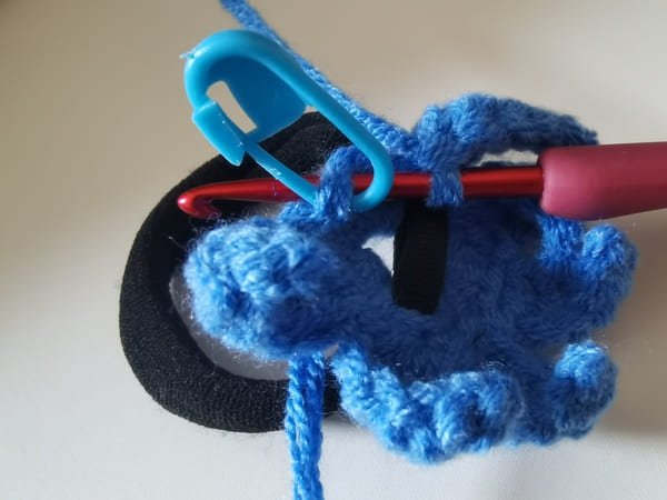 the hook in to the first stitch of previous round