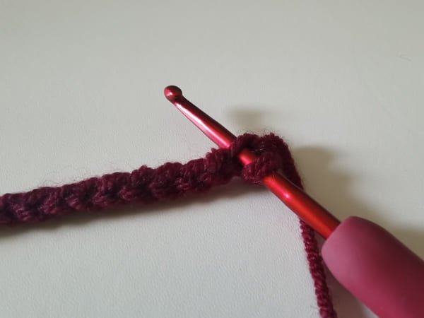 the hook starting from second to last stitch for crochet rose pattern