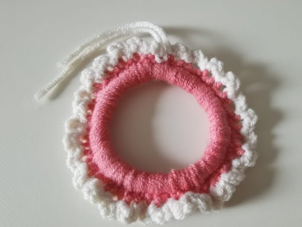 use hook to bring out yarn end for round 2
