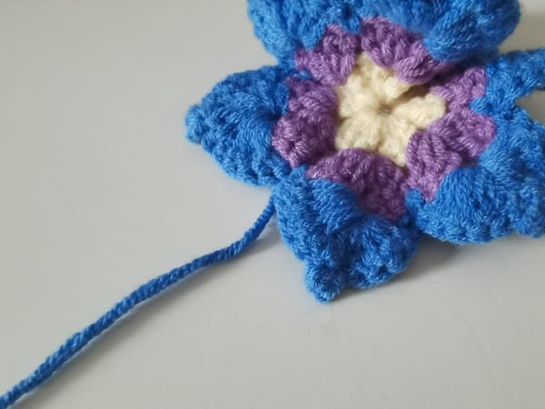 use hook to bring out yarn end for round 3 for crochet butterfly pattern
