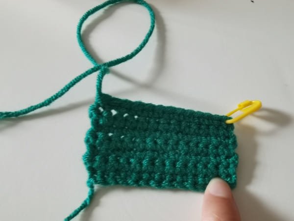 use the hook to bring out yarn end for frog crochet pattern